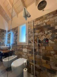 a bathroom with a shower and a toilet and a sink at Incanto Glamping village in Savio di Ravenna