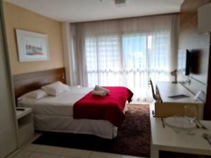 a hotel room with a bed and a large window at Lindo flat no Vision - centro de Brasília in Brasilia