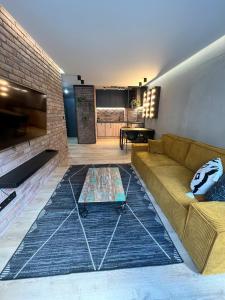 a living room with a couch and a table at Hi Apartments Kozia in Kielce