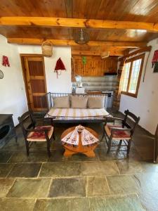 a living room with a couch and a table and chairs at Villa Kamari- Stunning Views in Kritsá