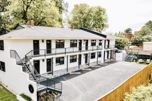 a white house with a staircase in front of it at The Moose at Memphis Downtown & Victorian Village in Memphis