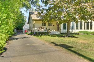 a yellow house with a tree and a driveway at Long Island Studio Vacation Rental 4 Mi to Beach 