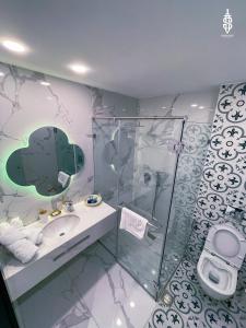 a bathroom with a shower and a sink and a toilet at Saladin Boutique Hotel in Jerusalem