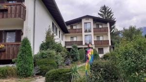 a large white building with a garden in front of it at Pension Katharina in Seeboden