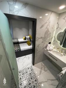a bathroom with a bed and a sink and a mirror at Saladin Boutique Hotel in Jerusalem +32 photos