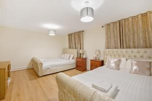 a living room with two beds and a couch at The Smeaton Apartment, Central City Centre in Plymouth