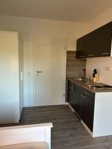 a kitchen with a white door and a counter top at Ferienwohnung & Zimmer in Olpe