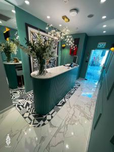 a lobby with a counter with a vase of flowers at Saladin Boutique Hotel in Jerusalem