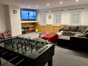 a living room with a pool table and a tv at Chata VISTA Strážné in Strážné