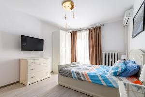 a bedroom with a bed and a dresser and a television at 10 Seconds Away from the Main street, Free Secured Parking in Sofia
