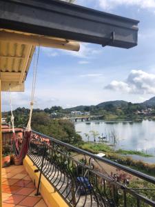 a balcony with a view of a river at Lake View Hostel in Guatapé