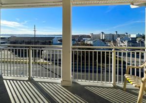 a balcony with a bench and a view of a city at Americana Condos 10th street in Ocean City