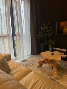 a living room with a coffee table and a couch at Troika Residency Kota Bharu by The Stay Homestay 1 in Kota Bharu