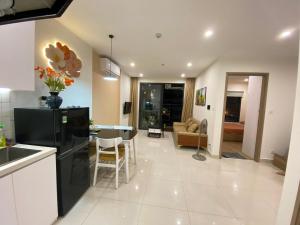 a kitchen and living room with a black refrigerator at Blue Ocean Homestay in Hanoi