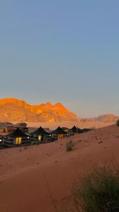 a group of huts in the middle of a desert at STAR CAMP & WiTH TOR in Wadi Rum
