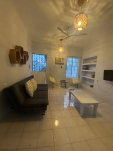 a living room with a couch and a table at Casa Colibrí in Cozumel