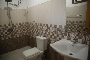 a bathroom with a toilet and a sink at Rivinu Holiday Resort in Ella +19 photos
