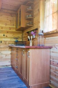 a kitchen with a wooden counter top in a cabin at Sowi Dworek in Sychowo