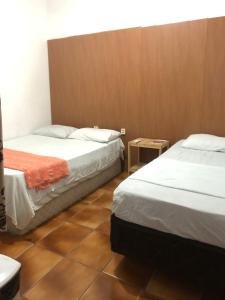 Кровать или кровати в номере Regiane Beach Pousada Hostel