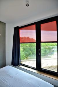 Voodi või voodid majutusasutuse Hôtel Belvue toas