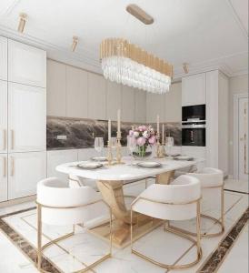 a white dining room with a table and white chairs at Special VIP Mariott Apartment in Baku
