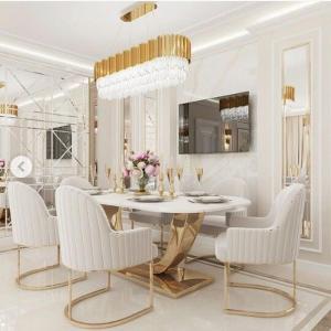 a dining room with a table and white chairs at Special VIP Mariott Apartment in Baku