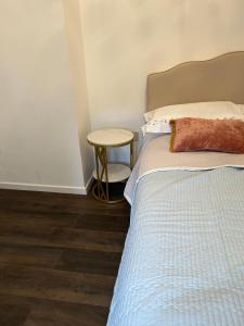 a bedroom with a bed and a side table at Victoria in London