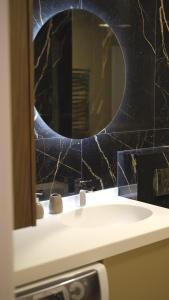 a bathroom with a sink and a mirror at Sunshine of Montenegro - Luxury in Kotor +40 photos