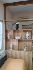 a room with wooden shelves with bowls and vases on them at Aleksinac Centar-Vojislav Eror in Aleksinac