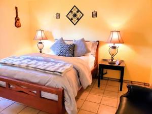 a bedroom with a bed and two lamps on tables at White Sands Casita in Alamogordo
