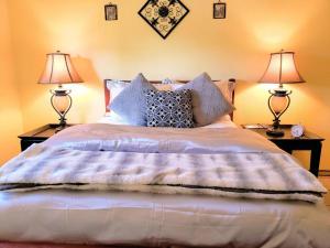 a bedroom with a large bed with two lamps at White Sands Casita in Alamogordo