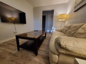 a living room with a couch and a table at Modern Private 1BR Apt. w/Free Prkg + Fast Wi-Fi in Sault Ste. Marie