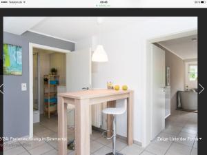 a kitchen with a wooden island in a room at Appartment Simmertal in Simmertal