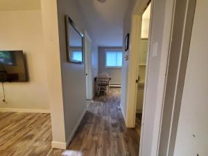 an empty hallway in a home with a hallway leading into a room at Modern Private 1BR Apt. w/Free Prkg + Fast Wi-Fi in Sault Ste. Marie