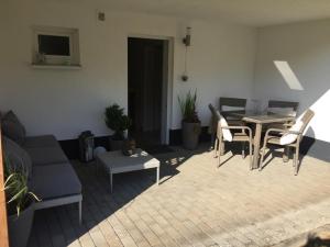 a living room with a couch and a table and chairs at Appartment Simmertal in Simmertal