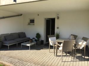 a patio with a couch and a table and chairs at Appartment Simmertal in Simmertal