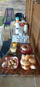 a table topped with lots of different types of food at Pousada Sossego do Tocantins in Lajeado