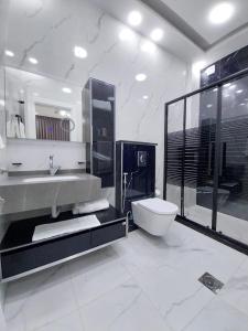 a white bathroom with a sink and a toilet at Sea view chalet in Taba
