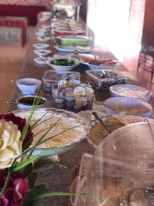 a long table filled with plates and bowls of food at Mira luxury camp in Wadi Rum