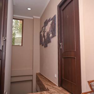 a hallway with a wooden door and a window at Sofia Hotel in Yerevan