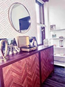 a dressing table with a mirror and a laptop on it at 2Br Unit W/ Cinema Room in Nulu in Louisville