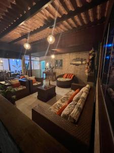 a large living room with a couch and a table at Pousada da Leide in Fernando de Noronha