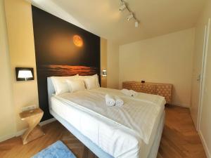 a bedroom with a large bed with two towels on it at Lavish Inn Apartment in Cluj-Napoca