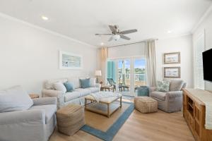 a living room with a couch and a tv at Pescador Landing 6A in Pensacola