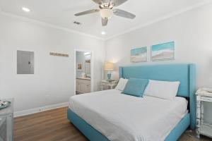a bedroom with a blue bed and a ceiling fan at Pescador Landing 6A in Pensacola