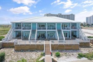 a large blue house with a large deck at Pescador Landing 6A in Pensacola