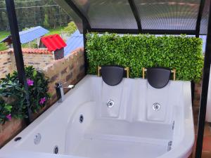 a bath tub with two pots on top of it at Glamping VILLA - Nueva en Paipa in Paipa