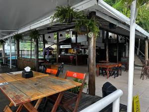 a patio with tables and chairs in a restaurant at DerSalvador Sol Victoria Marina Studios in Salvador