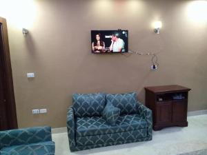 - un salon avec un canapé et une télévision murale dans l'établissement Apartment, à Hurghada
