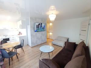 a living room with a couch and a table at New Energia apartment in center city in Narva
